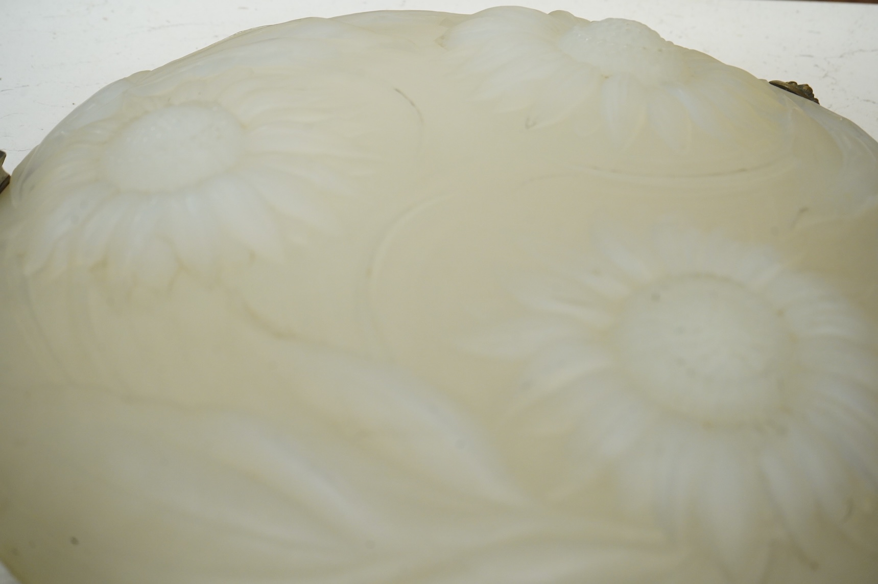 A Lalique style opalescent glass ceiling shade decorated with three sunflowers, 34cm in diameter